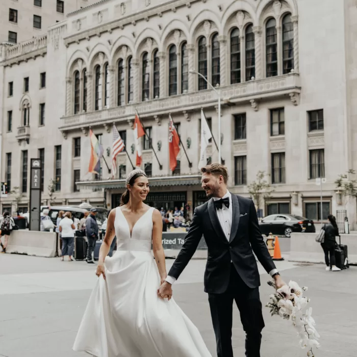 Wedding couple in front of historical architecture