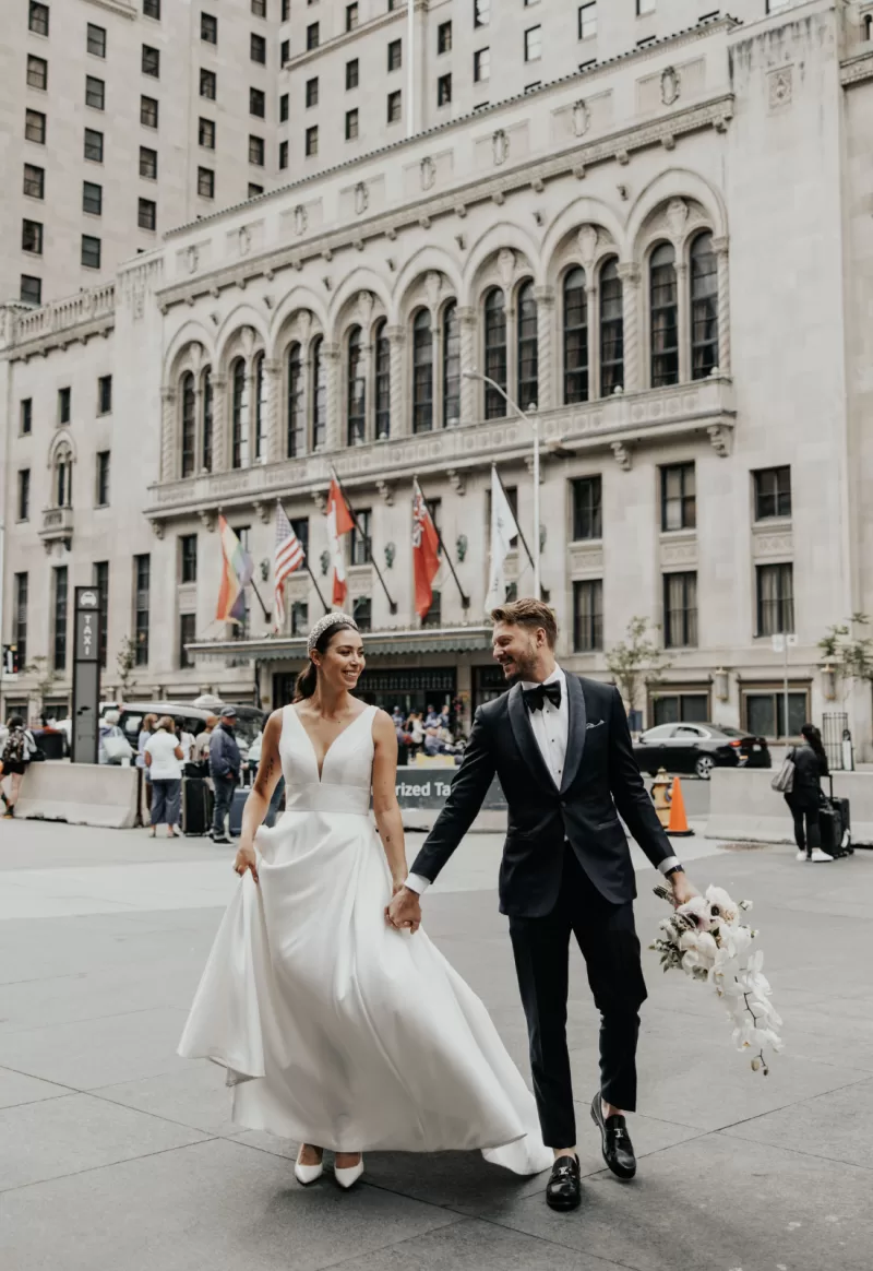Wedding couple in front of historical architecture